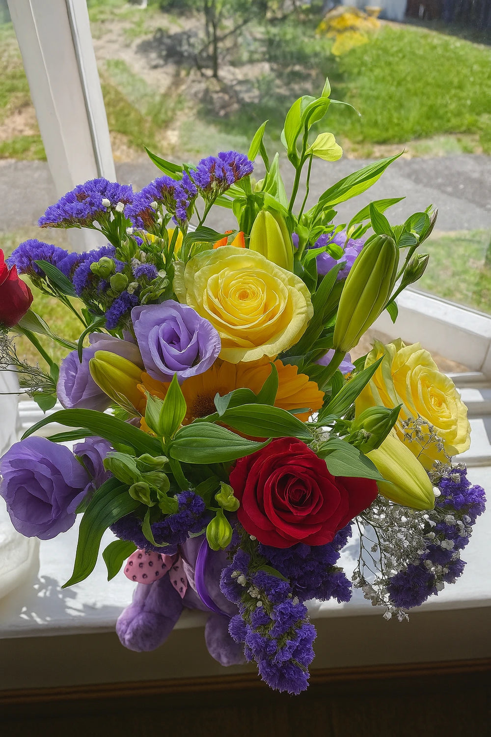 Purple and yellow flower bouquet with roses and lilies