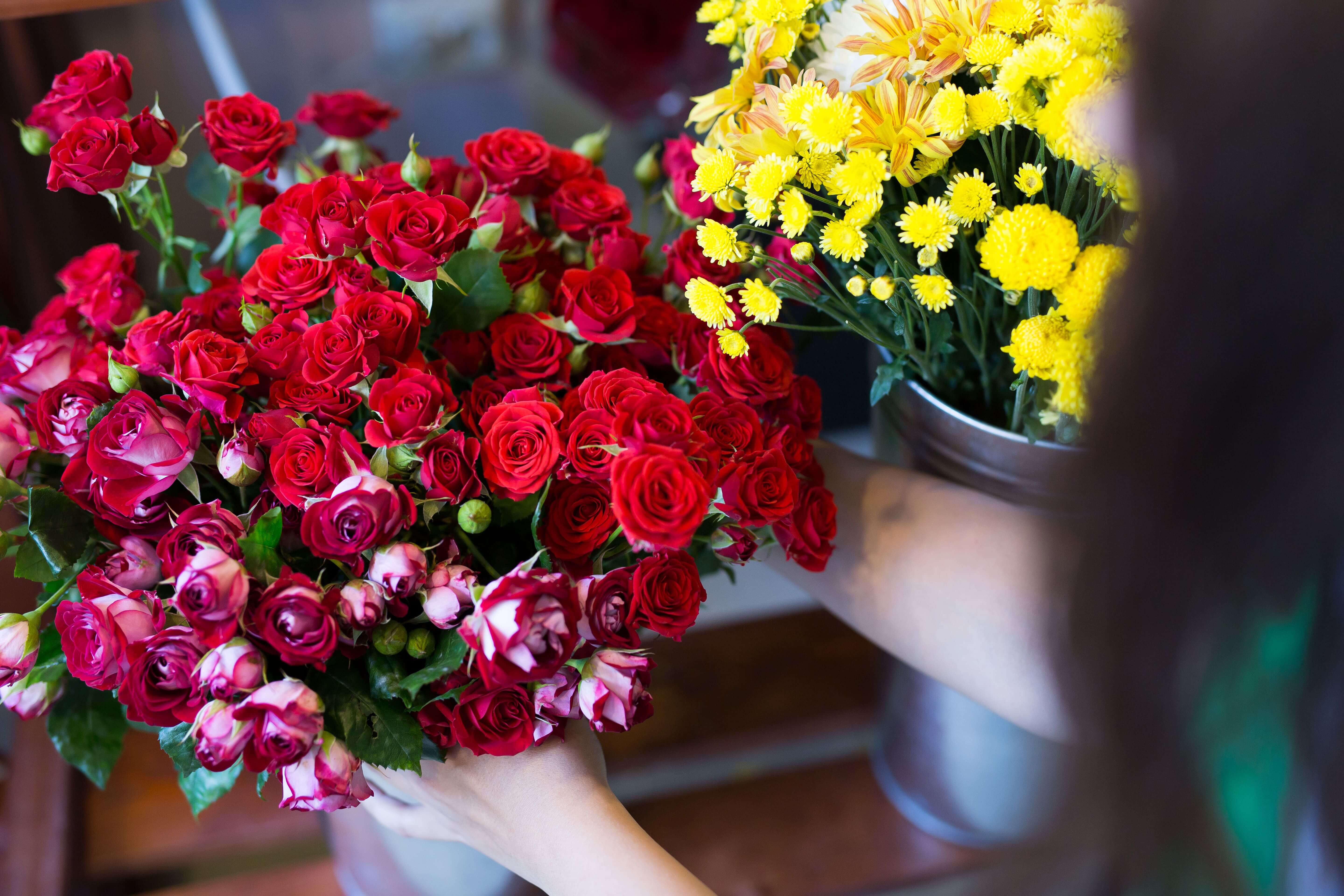 Flower bouquet of red roses and yellow flowers