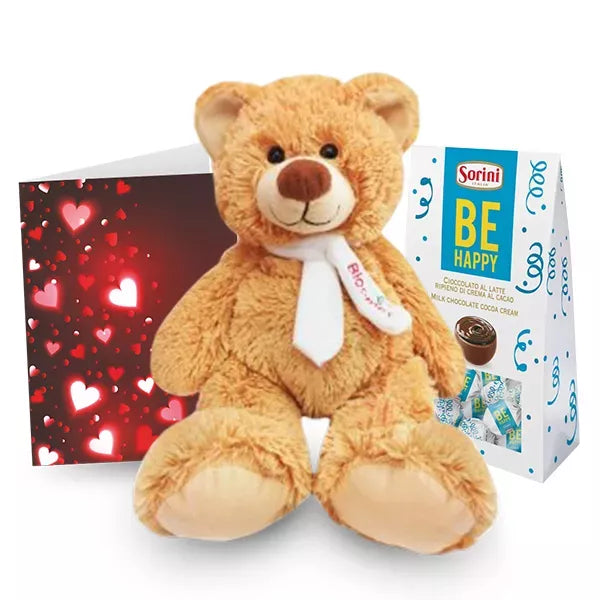 Plush teddy bear with heart-patterned card and box of Sorini milk chocolates.
