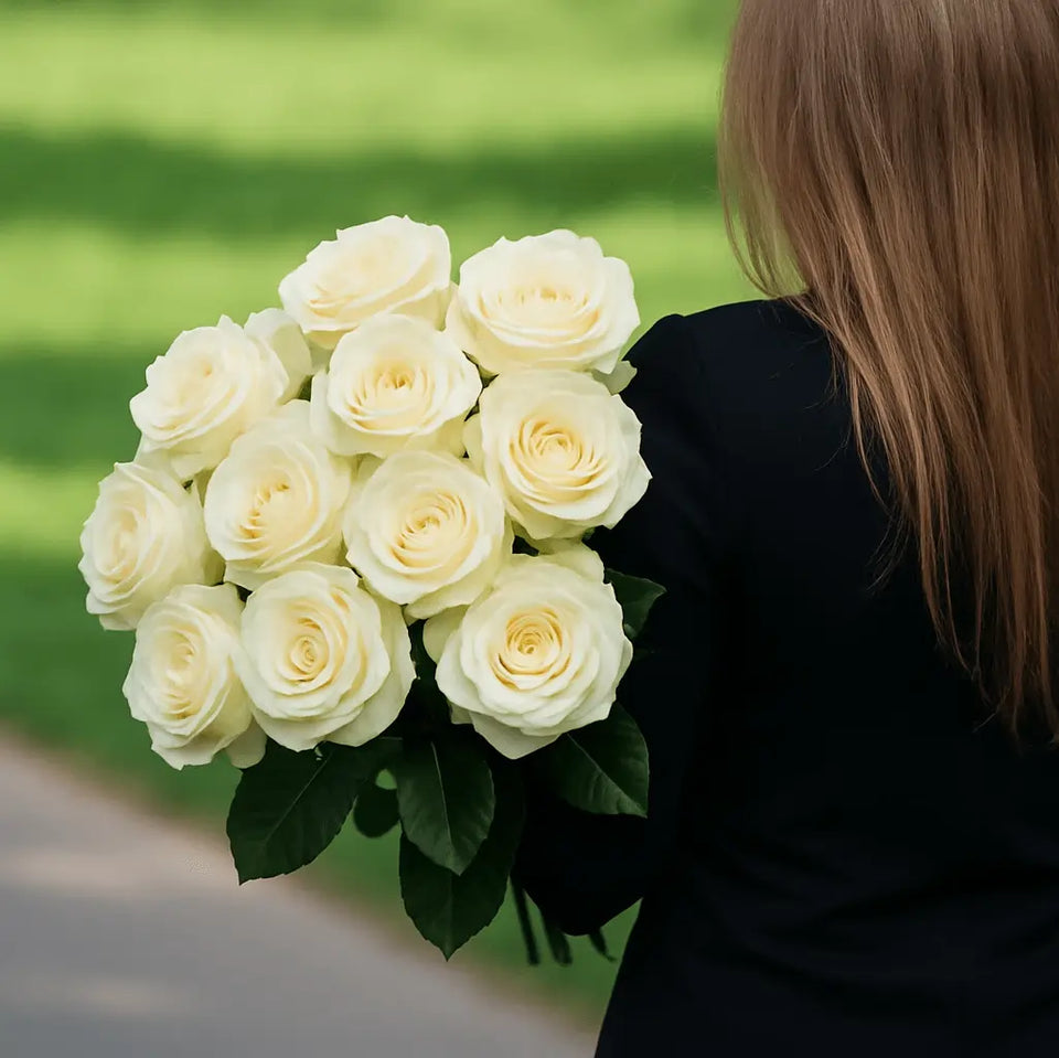 Woman holding white roses for a funeral