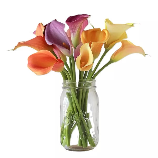A bouquet of colorful calla lilies in a glass mason jar.
