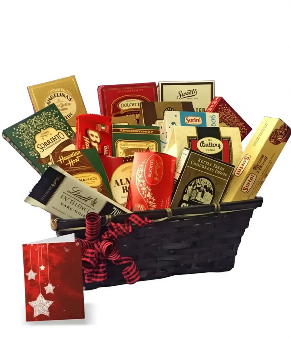 Deluxe Christmas gift basket with assorted chocolates, truffles, and sweets in a black basket with red ribbon and holiday card.